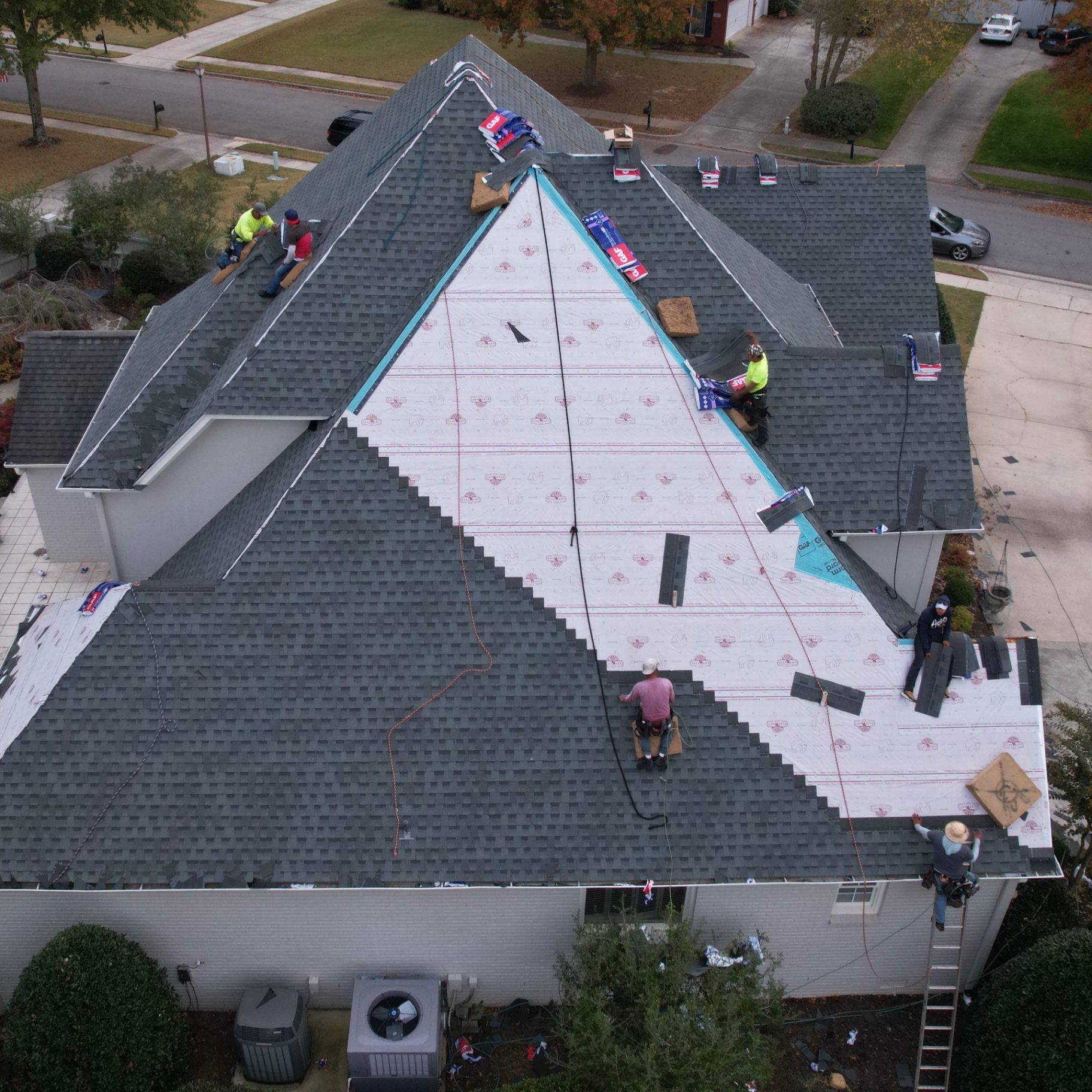 Drone view of GAF FeltBuster synthetic underlayment and StormGuard installed as shingles go on