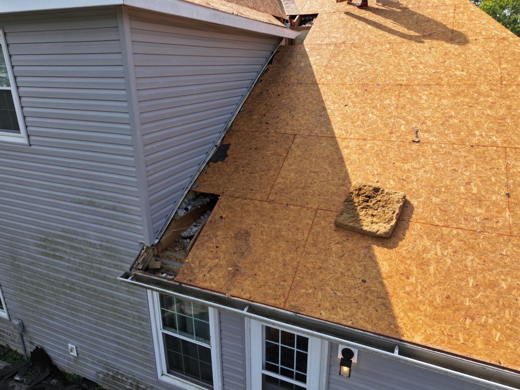 Deteriorated fascia and edge decking exposed during tear-off on a two-story home, photographed by drone