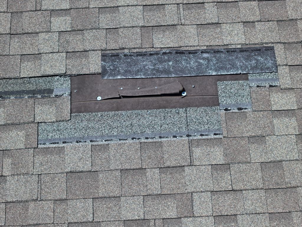 Close-up drone view of an open shingle course with exposed underlayment before the repair is completed